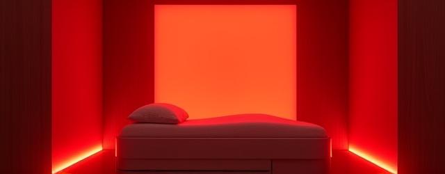 Advanced wellness device emitting red light in a modern home setting, symbolizing home recovery lab.